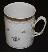 A Chinese porcelain armorial tankard of large proportions, polychrome decorated with floral sprigs,