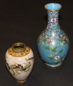 A Chinese cloisonné baluster shaped vase with flared rim decorated with flowers on a  turquoise