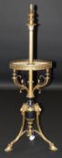 A circa 1900 gilt brass standard lamp in the Empire taste, the telescopic column converted from