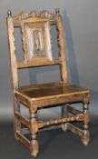 A 17th Century and later oak hall chair,