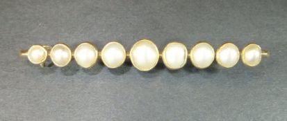 A yellow metal 9 pearl set bar brooch, approx 5.