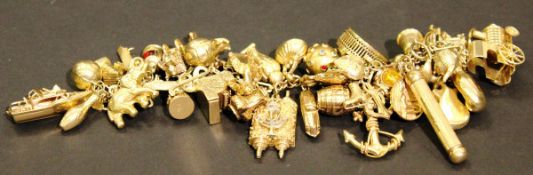A gold charm bracelet set with 44 various charms (mainly modern),