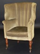 A 19th Century mahogany framed barrel back green upholstered wing armchair, on turned and ringed