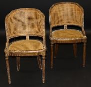 A pair of 19th Century French carved giltwood framed bérgère salon chairs on turned and fluted