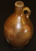 A 17th Century salt-glazed flagon with loop handle and winged decoration to neck,