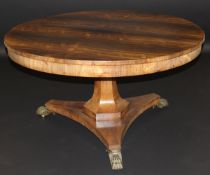 A William IV circular rosewood tilt-top dining table, the plain top over a plain frieze to a