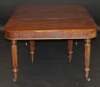 A Regency mahogany extending dining table, the plain rounded rectangular top above a plain frieze on