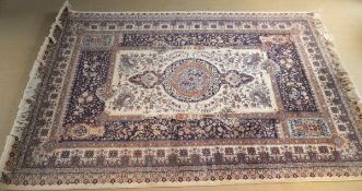 A Persian rug, the central medallion in cinnamon, pale peach,