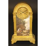 A 19th Century French gilt metal cased mantel clock in the Louis XVI taste, the domed top with egg