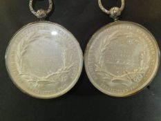 Two white metal Birmingham Agricultural Exhibition Society medallions depicting cattle and sheep