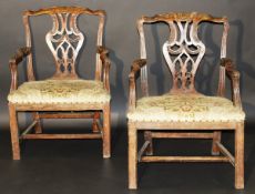 A pair of George II Irish walnut framed carver dining chairs in the Chippendale taste, the carved