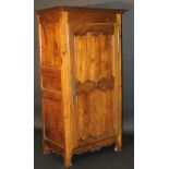 An early 19th Century French chestnut and fruitwood armoire,