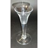 A mid 18th Century wine glass with trumpet shaped bowl to solid plain stem and conical foot, 17.