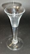 A mid 18th Century wine glass with trumpet shaped bowl to solid plain stem and conical foot, 17.