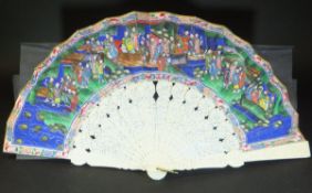 A late 19th Century Chinese carved ivory and paper fan painted with figures within a Court scene,