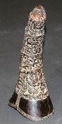 A 19th Century Chinese carved rhino horn with all over pierced decoration of flowers, fungi and