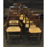 A composite set of eight North Country elm and oak spindle back rush seat dining chairs in the 17th