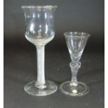 A mid 18th Century goblet with a tall waisted cup shaped bowl and multiple spiral air twist stem