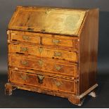 An early 18th Century walnut and feather banded bureau,