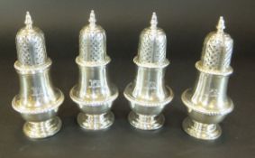 A set of four George V silver peppers of baluster form,