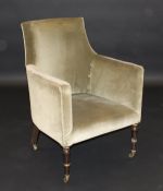 A 19th Century green velvet upholstered tub armchair on turned and ringed ebonised and gilt