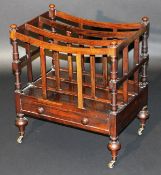 A 19th Century rosewood three section Canterbury with single drawer on turned and ringed legs to