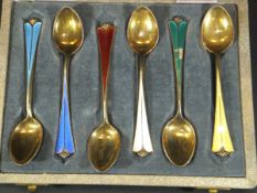 A cased set of six David Andersen silver gilt and coloured enamel coffee spoons,