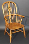 An early 20th Century beech and elm Thames Valley Windsor wheel and stick back armchair, bearing