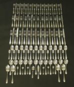 A mahogany cabinet containing a twelve place setting canteen of silver cutlery (by Emile Viner,