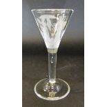 A wine glass with conical shaped bowl engraved with two ladies with conical hats,