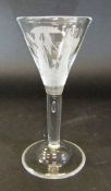 A wine glass with conical shaped bowl engraved with two ladies with conical hats,