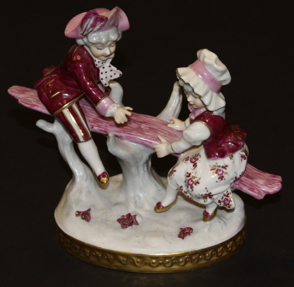 A 20th Century Continental porcelain figure group "See-saw",