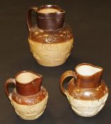A harlequin set of three late 19th / early 20th Century stoneware harvest jugs,