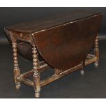 An 18th Century style oak oval drop leaf gate leg dining table,
