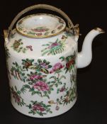 A Chinese porcelain cylindrical teapot decorated in the famille-rose palette with flowering