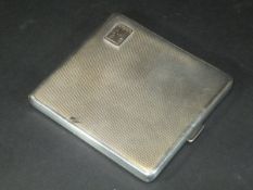 A George V silver cigarette case with engine turned decoration and initialled "FMP" to front (by