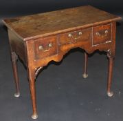 An 18th Century oak lowboy,