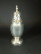 A George V silver sugar caster of baluster shaped form,