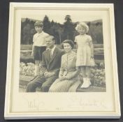 A framed and glazed image of Her Majesty The Queen and Prince Philip with Prince Charles and