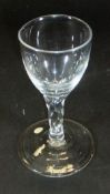 A late 18th Century wine glass with ogee shaped bowl, facet cut stem and plain foot, 12.