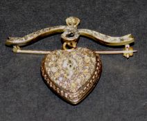 A 19th Century gold and diamond set love heart pendant locket on a ribbon mount, approx 3.