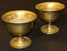 A pair of 19th Century Indian brass vases of cup form,