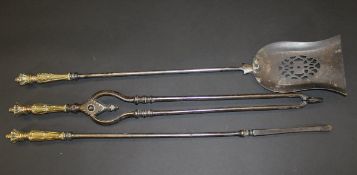 A set of three steel fire irons with cast brass handles decorated with crown finials,