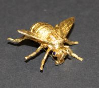 An 18 carat gold bee brooch set with sapphire eyes and diamonds to it's back, approx 11.4 g total