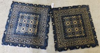 A pair of Chinese throne rugs, the square centre field with all-over foliate decoration in cream,