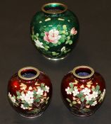 A pair of 20th Century Japanese cloisonné vases with floral decoration on a red ground, 9 cm high,