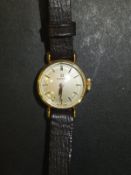 A ladies gold cased Omega wristwatch, the circular dial inscribed "Omega Swiss Made" with brown