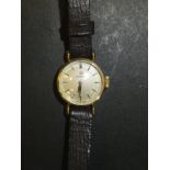 A ladies gold cased Omega wristwatch, the circular dial inscribed "Omega Swiss Made" with brown