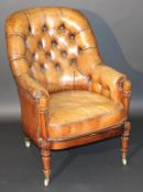An early 19th Century rosewood show framed brown leather button back armchair on carved and turned