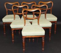 A set of six Victorian mahogany kidney back dining chairs with carved back rail to pale yellow and
